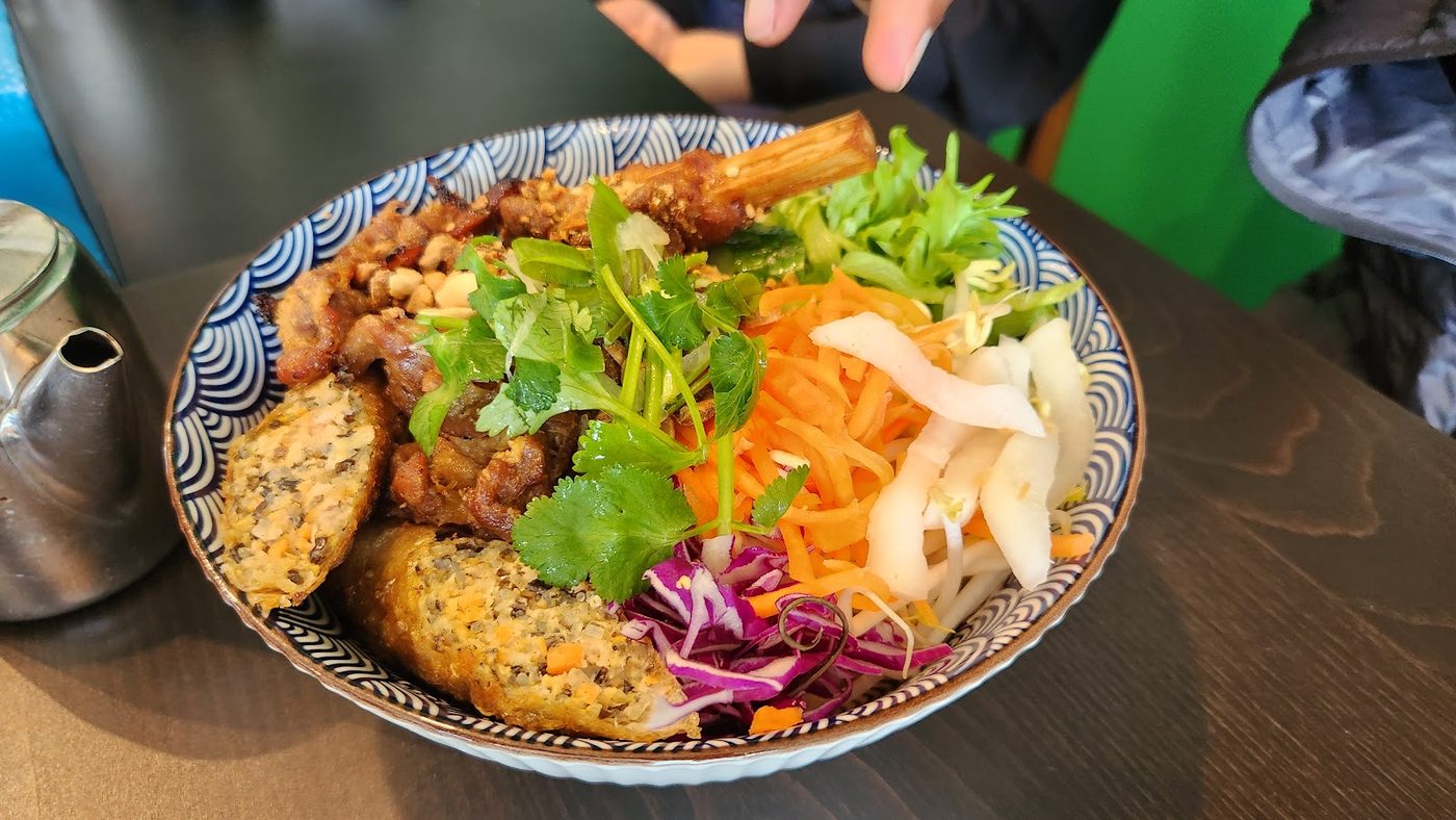 Fresh vermicelli bowl with herbs, pickled vegetables and savoury toppings